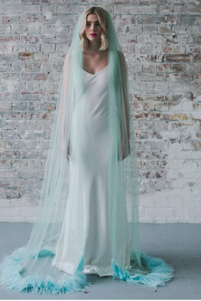 bedew wearing a mint green cathedral veil edged with feathers